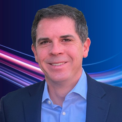Promotional graphic for Prime announcing James Karcher joining the senior executive team as Global EVP, Medical Communications, AI and Digital Healthcare; company logo and headline over a portrait of Karcher in a suit against a blue‑purple wave background.